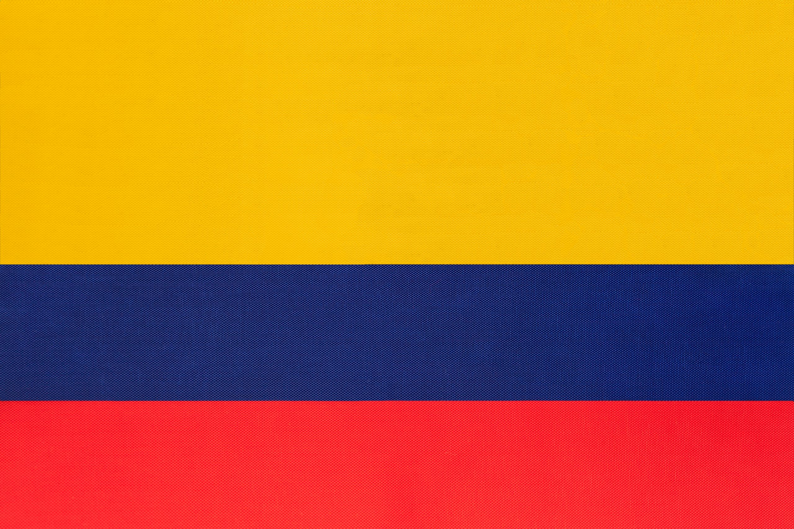 Colombia national fabric flag textile background. Symbol of international world south America country. State official colombian sign.